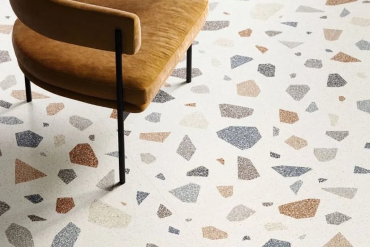 Stylish terrazzo flooring with large aggregate stone chips under a lounge chair in Dammam, Saudi Arabia by Floroz