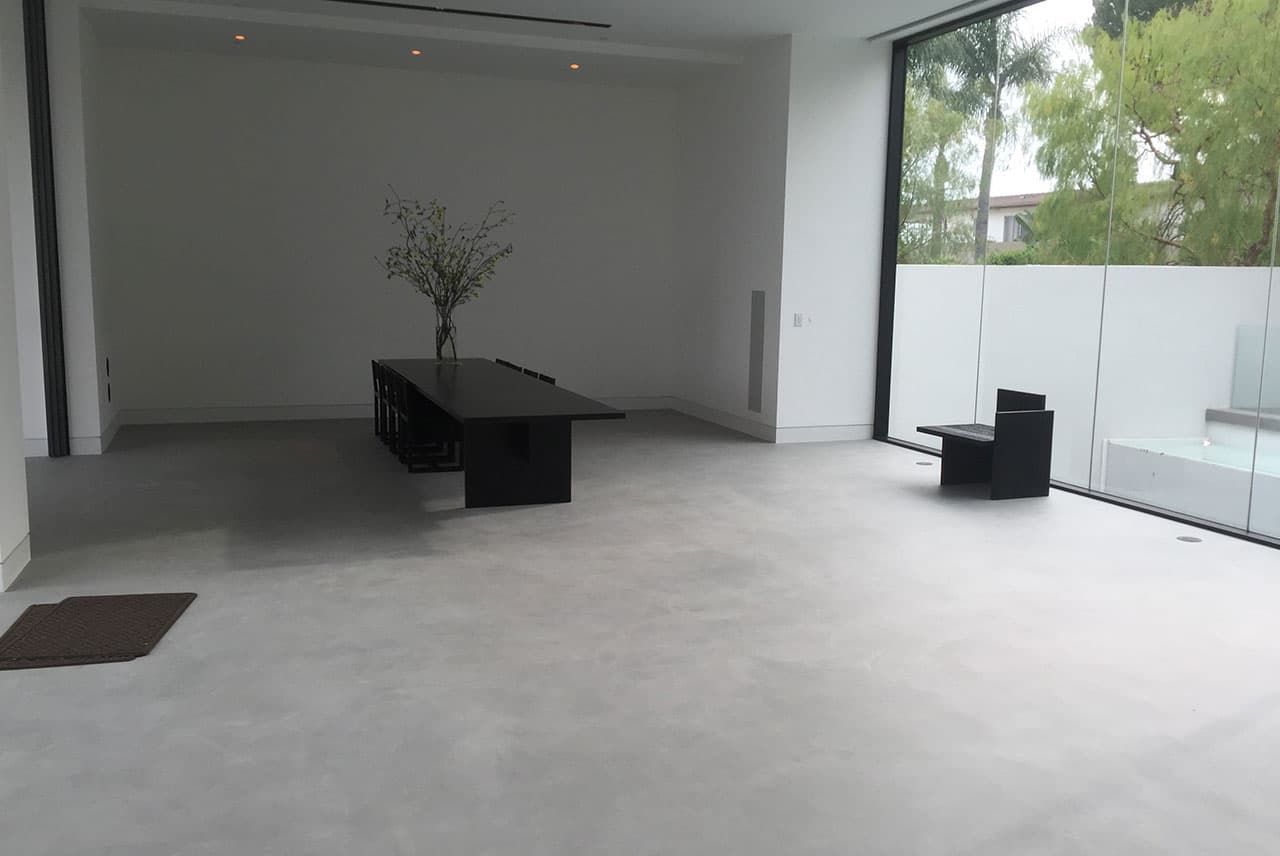 Modern microcement open-plan apartment in Jeddah showing seamless integration between living areas