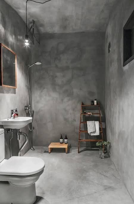 Industrial dark grey microcement bathroom with waterproof walls and wooden accents