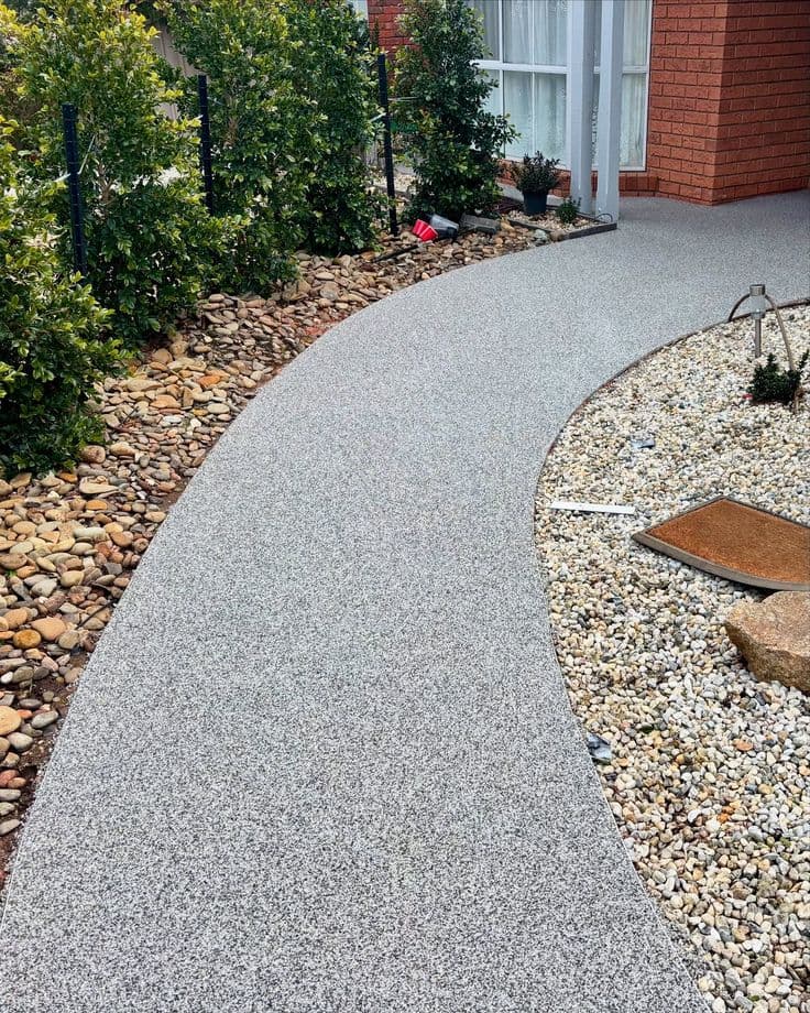 Charcoal aggregate resin-bound car park surface with demarcation line and SUDS drainage