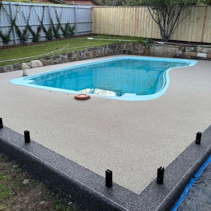 Silver grey resin-bound terrace with border feature and integrated drainage channel