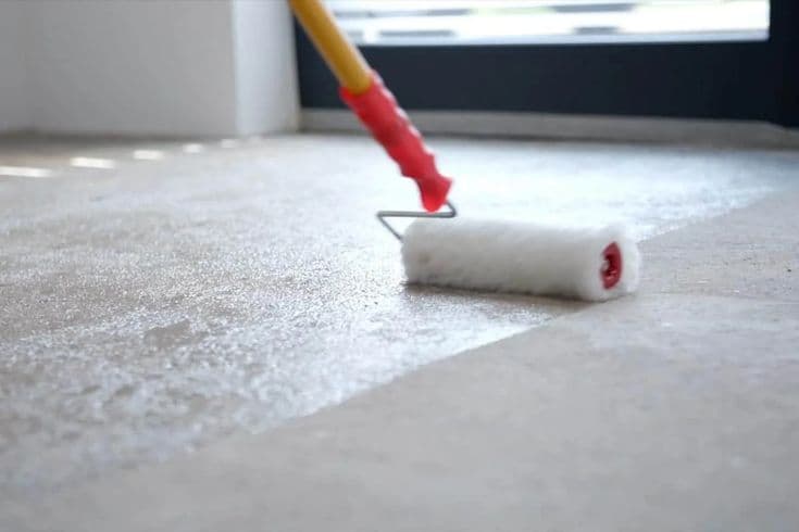 Applying the final protective sealer on a microcement floor