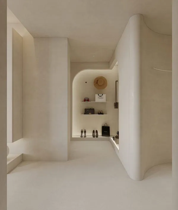 Luxury entryway with dramatic curved microcement walls and integrated lighting.