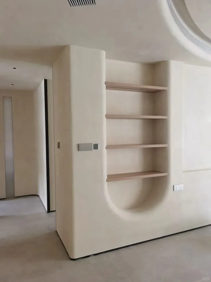 Custom built-in wall niche and shelving unit finished in seamless microcement.