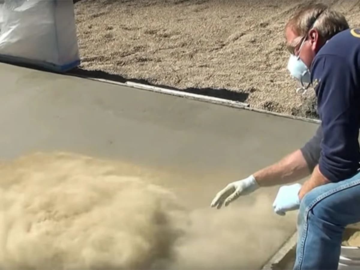 Floroz technician applying premium color hardeners for stamped concrete artistry in Saudi Arabia