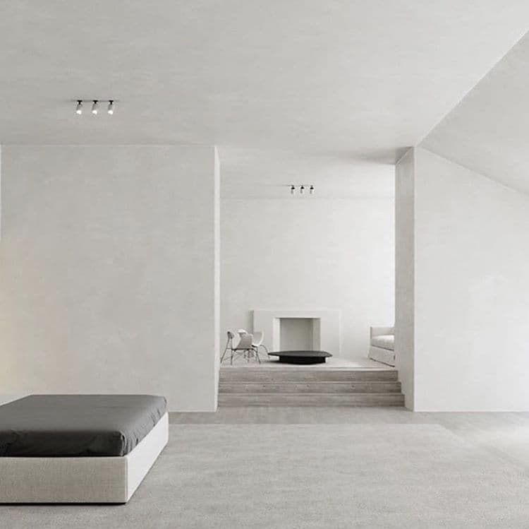 Minimalist bedroom in Riyadh with microcement flooring, modern gray and white interior showcasing heat-resistant luxury design for 50°C summers