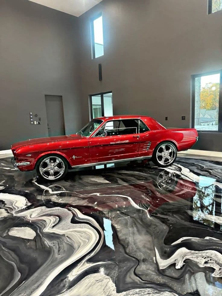 High-gloss black and white metallic epoxy garage floor with a marble effect finish.