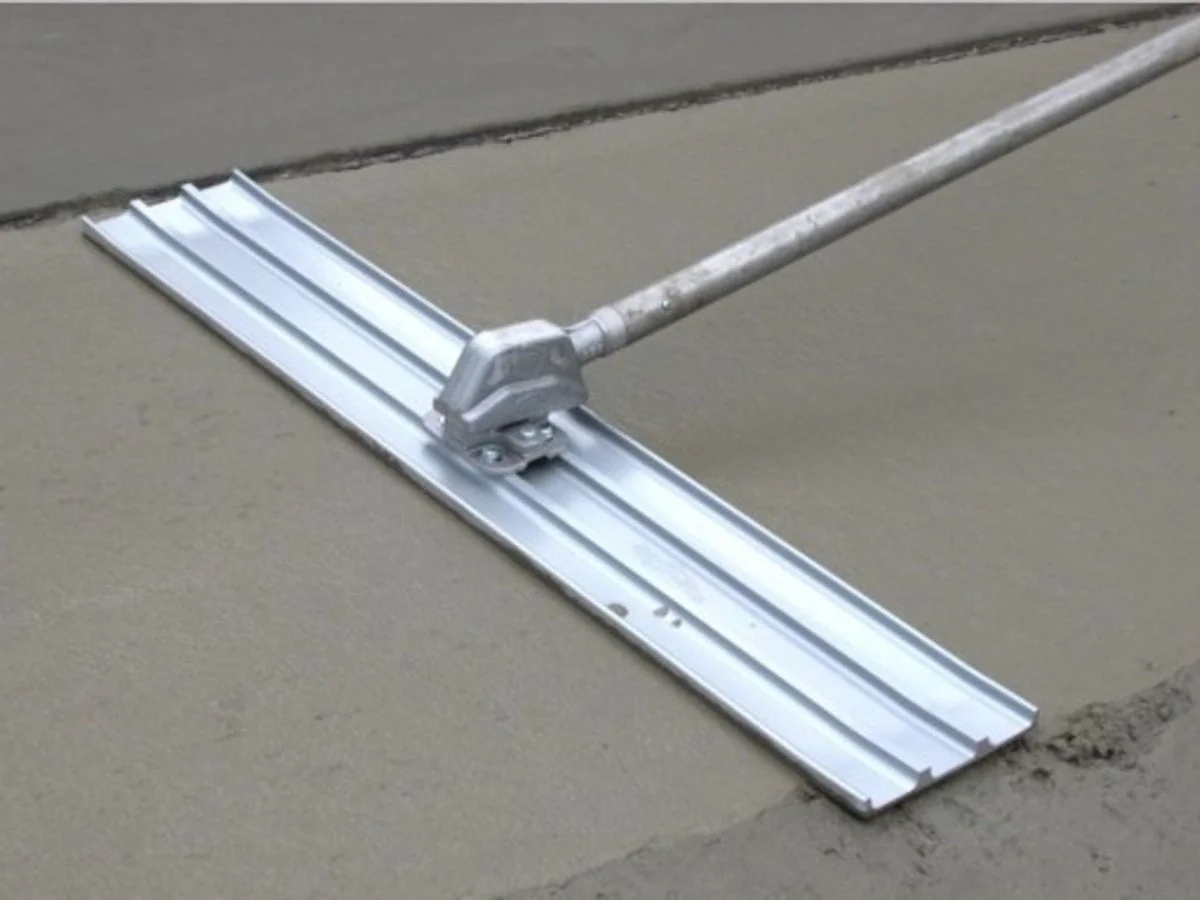 Geotextile separation layer and granular base installation for stamped concrete drainage