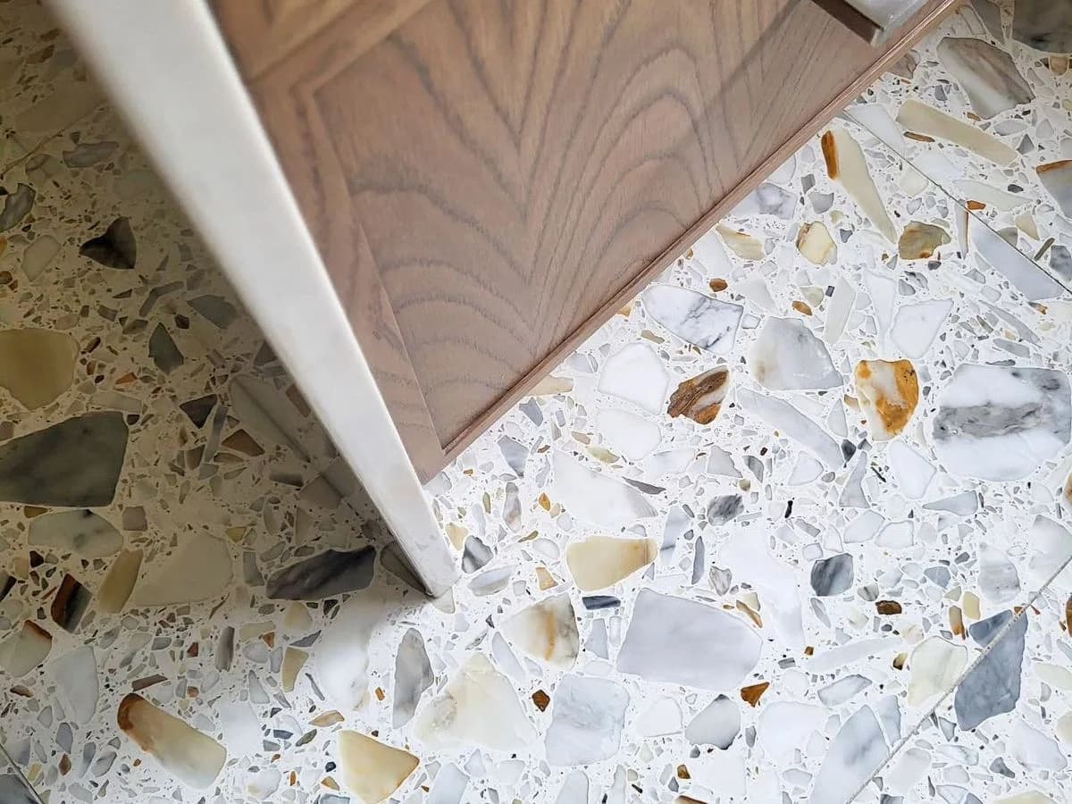 White marble chip terrazzo flooring in luxury retail store with high-gloss finish