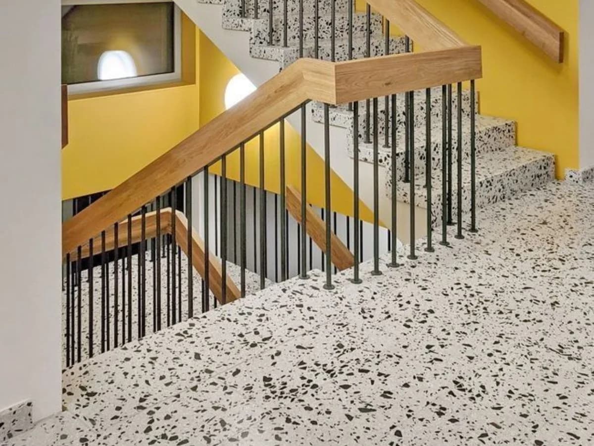 Feature terrazzo staircase with decorative aggregate inlay and brass nose strips
