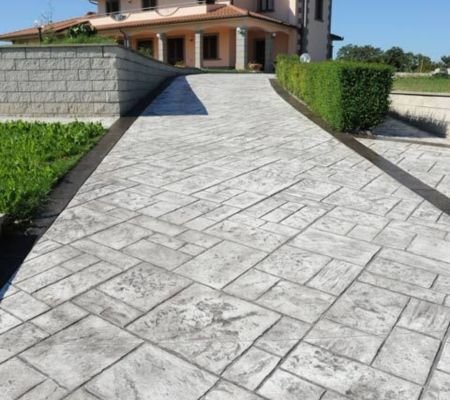Decorative stamped concrete flooring in Riyadh imitating natural wood stone slate patterns for sustainable outdoor applications