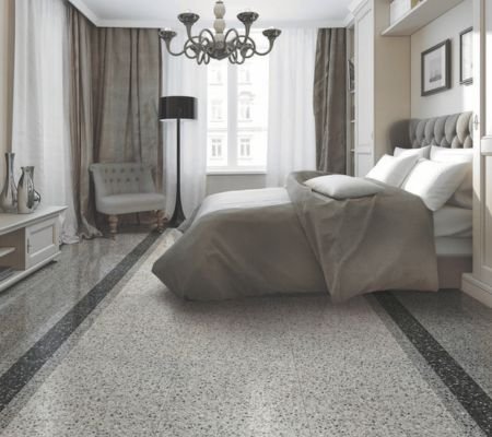 Modern Riyadh bedroom with speckled terrazzo flooring, black border trim, and chandelier under Saudi sunlight