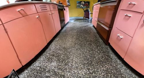 Polished terrazzo floor in a Jeddah kitchen after grouting and sealing, featuring a glossy finish with embedded aggregates.