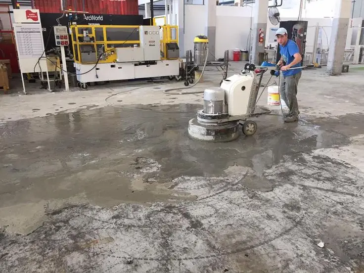 Planetary diamond grinder removing laitance and establishing the concrete surface profile