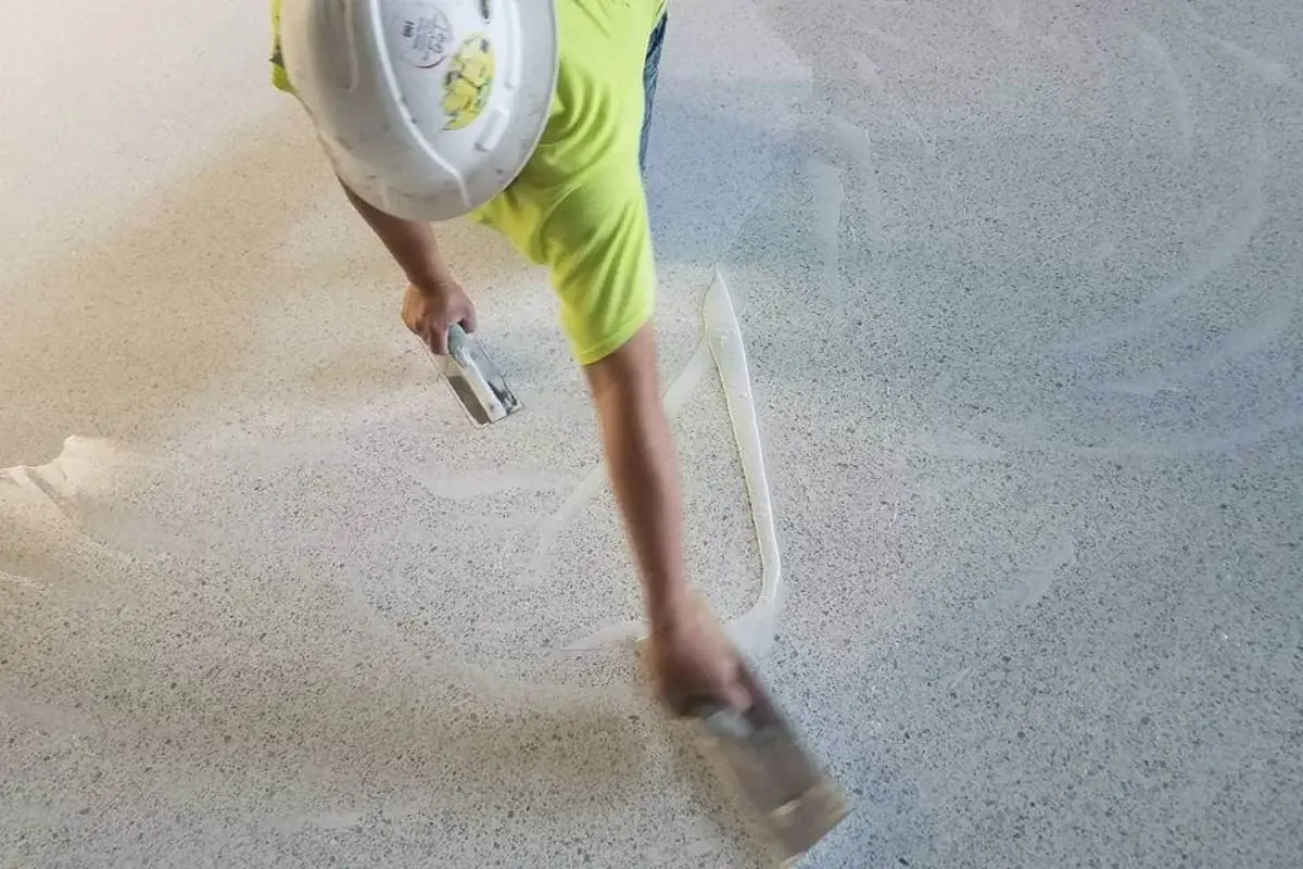 Aliphatic epoxy terrazzo being poured and hand-troweled at the installation site