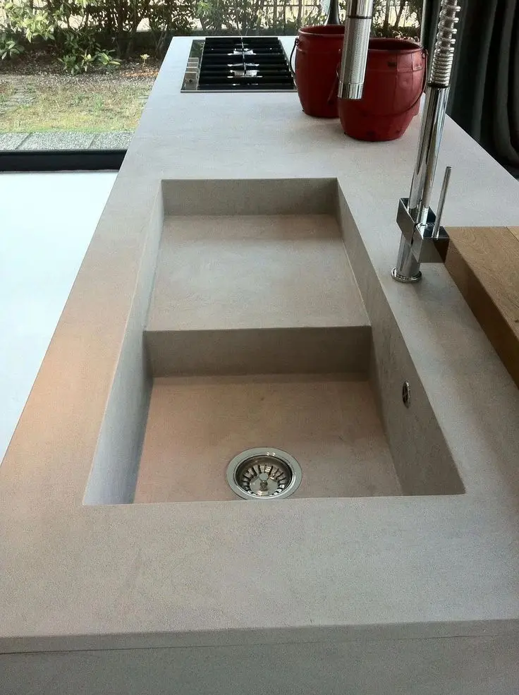 Integrated microcement kitchen sink formed seamlessly into the countertop.