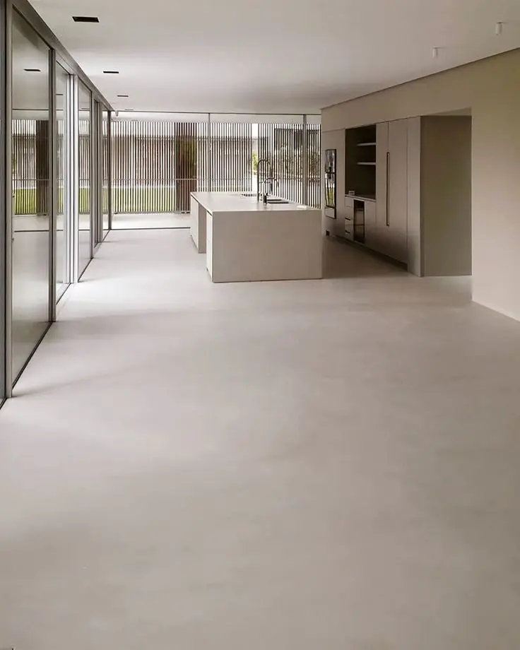 Seamless grey microcement kitchen floor providing a hygienic and easy-to-clean surface.