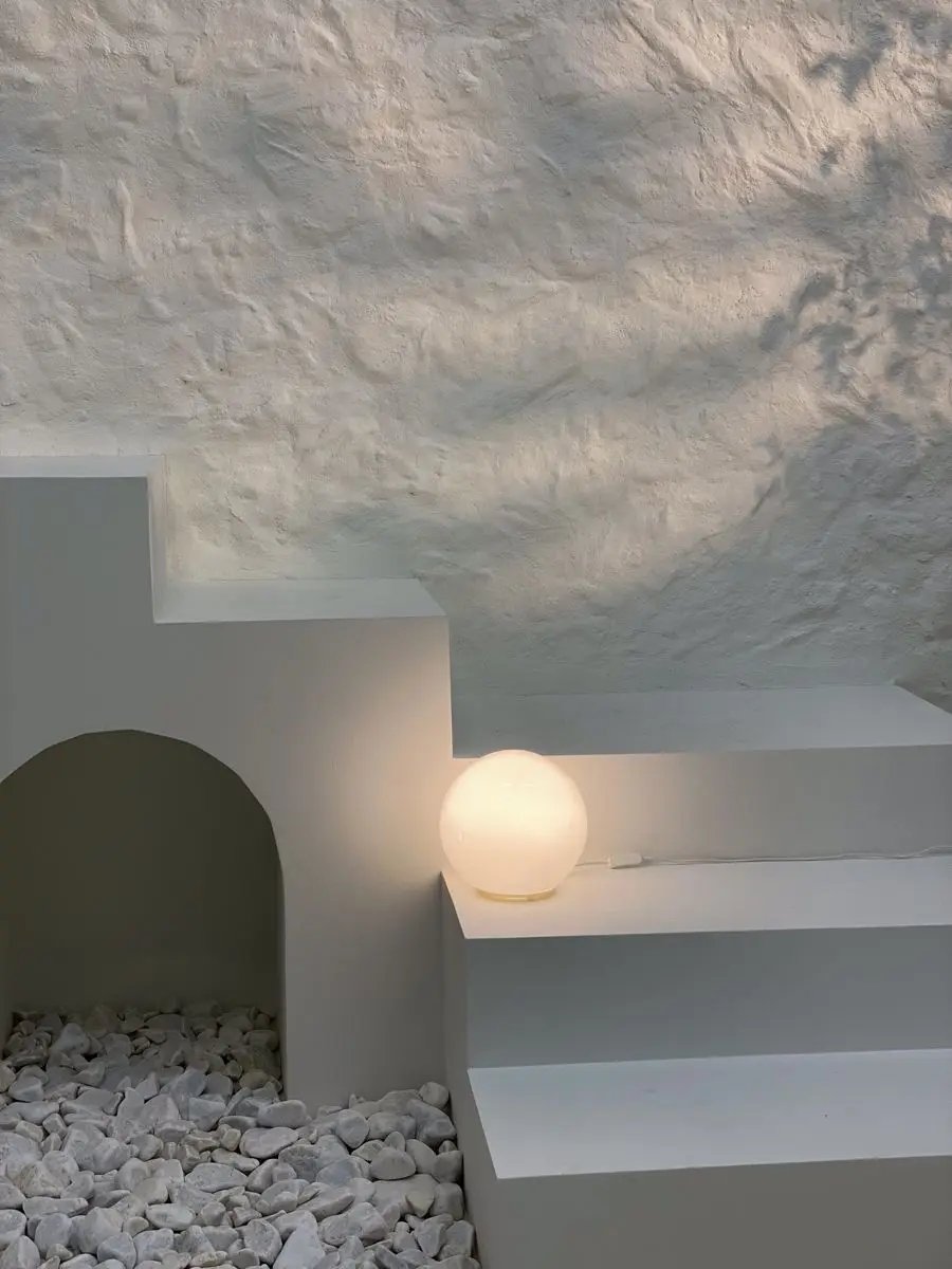 White textured microcement on outdoor wall and ceiling creating continuous mineral surface